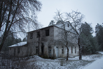 abandoned building in the winter forest