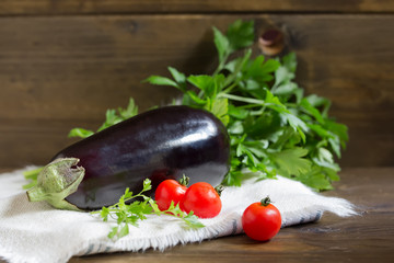 One organic fresh eggplant on wooden background