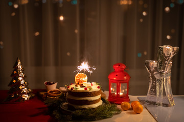 A Sparkler in the cake at night at Christmas time