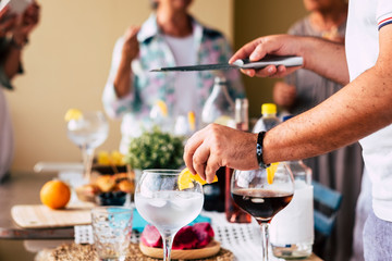 closeup man's hand prepare wine and cocktail for friends at home before the dinner together in...