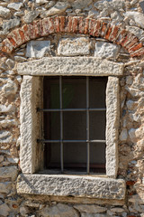 Fototapeta na wymiar Old Window with Iron Grating - Tuscany Italy
