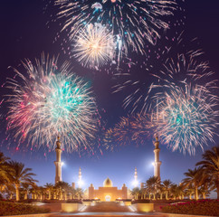 Beautiful fireworks above Sheikh Zayed Grand Mosque at sunset Abu-Dhabi, UAE