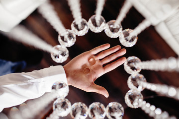 hand with chain on wooden background