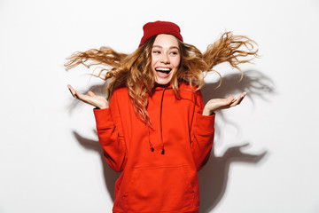 Portrait of an excited girl wearing hoodie jumping