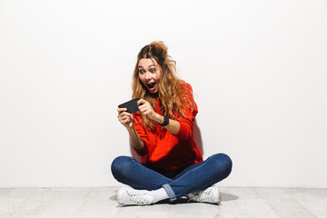 Portrait of an excited young woman wearing hoodie