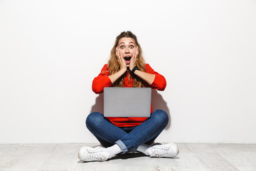 Portrait of an excited young woman wearing hoodie