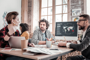 Stylish bearded man sitting in semi position