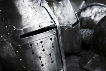 Steel medieval helmets with eyes slits side view. Black and white photo.