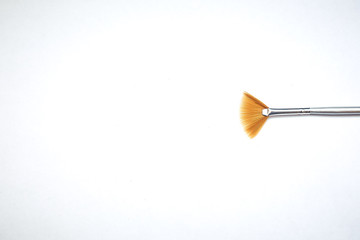 Drawing tools, set of dirty paint brushes in row on white isolated background, copy space, top view