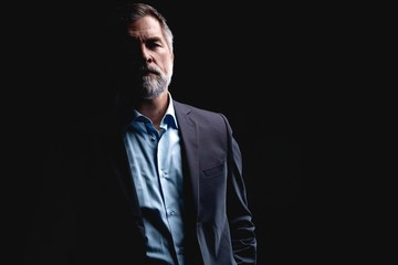 Handsome mature business man isolated on black background