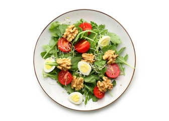 Delicious fresh salad with walnuts on plate, isolated on white