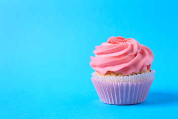 Tasty cupcake on color background