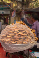 Indian street food vendor sell Fresh Samosa  and kachoris,a popular variety in a busy road of Delhi
