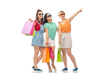 Obraz premium sale, friendship and people concept - happy smiling female friends shopping bags over white background
