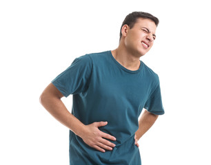 Obraz premium Young man suffering from abdominal pain on white background