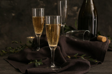 Glasses of champagne on dark table