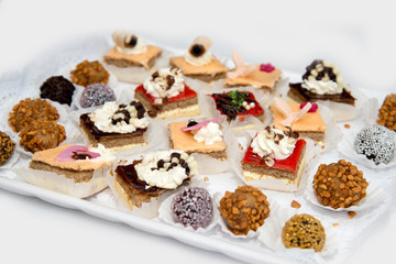 Catering sweets, closeup of various kinds of cakes on event or wedding reception  - selective focus