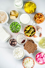 Super Healthy Probiotic Fermented Food Sources, drinks, ingredients, on white marble background copy space top view