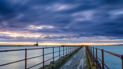 Mouth of the River Blyth in Blue Hour, as the river reaches the North Sea between the piers of Blyth Harbour in Northumberland