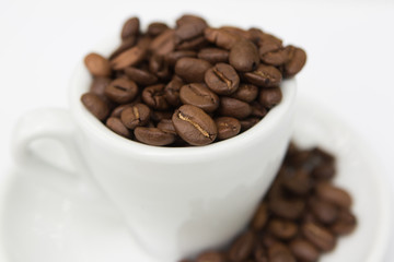 top view cup with coffee seeds and beans isolated on white backgorund. tasty morning drinks and beverages.