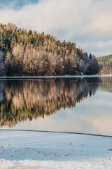 Incredible reflections in the lake with beautiful sunset light. The first frosts in Scandinavia, Finland