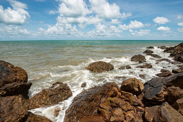 Fototapeta na wymiar Beach with rocks and cloudy sky in Thailand