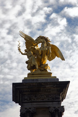 golden sculpture called Sciences statue in Paris