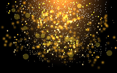 
Glowing gold dust or snowflakes on a black background with bokeh effect