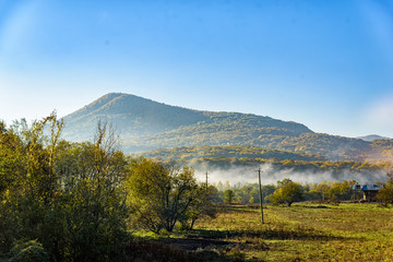 Naklejka premium Beautiful mountain landscape with rocks and fog