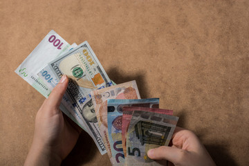 Hand holding American dollar  isolated on wooden background