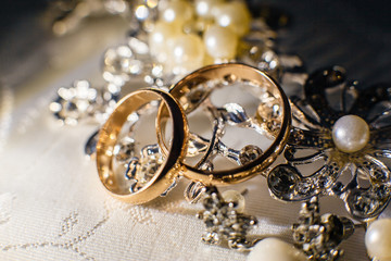 Wedding rings and shiny jewelry of the bride