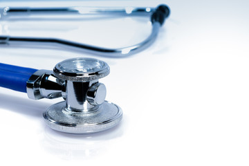 Blue stethoscope or phonendoscope on white surface with copy space. Medical equipment