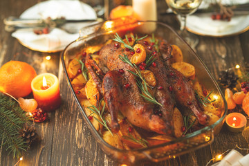 Roast duck. Thanksgiving table served with turkey, decorated with rosemary and pomegranate seeds and candles. Roast duck, table. Christmas dinner, Flat lay