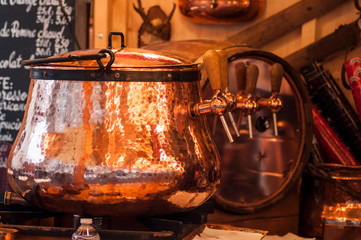 closeup of mulled wine in traditional copper cauldron at the christmas market