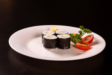 Sushi plate on black background