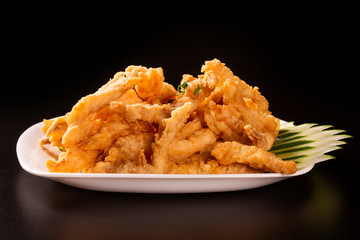 Fried Fish Fingers on black background