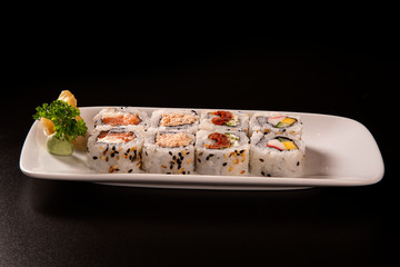 Sushi plate on black background