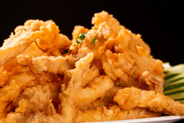 Fried Fish Fingers on black background