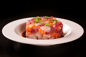 A delicious tartare of fresh Mediterranean tuna, salmon and white fish. Seasoned with extra virgin olive oil, chives, parsley and a drops of orange juice