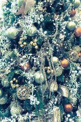 Close up on christmas tree decorations, vintage style cross processed effect