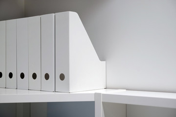 Office folders for documents. A folder with files on the sideboard in a bright modern office, archive and documents