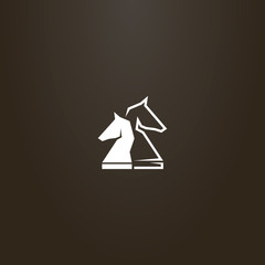 white sign on a black background. vector sign of two chess knight pieces