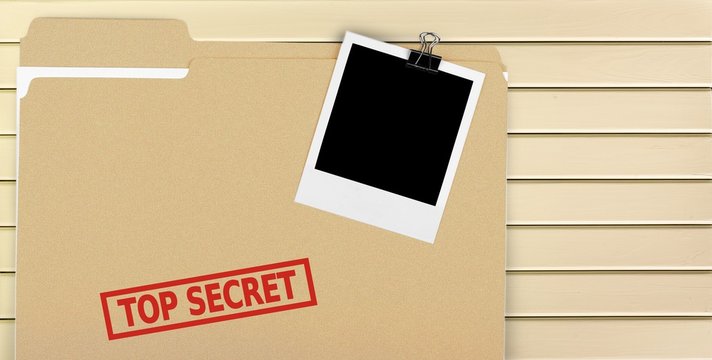 A manila folder with the faded words Top Secret on the front