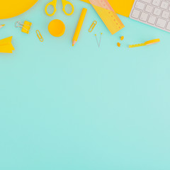 Creative flat design full of supplies on mint background. Top view.