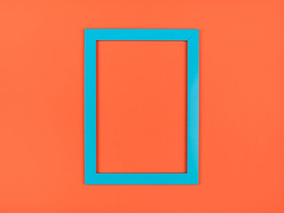 Empty picture frame on textured pastel colored background