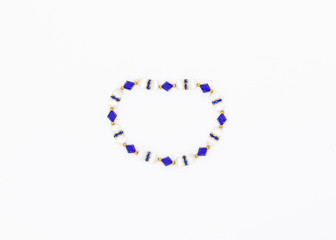blue and white colored and variously sized beads bracelet on white background