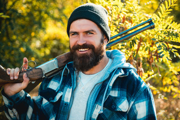 Pictures for Barbershop. Bearded hunter man holding gun and smile. Hunter with long beard on hunt....