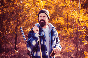 Hunter with shotgun gun on hunt. Autumn hunting season. Hunter in the fall hunting season. Autunm...