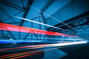 abstract image of blur motion of cars on the city road at night，Modern urban architecture in...