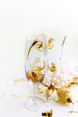 Champagne glasses with golden glitter. Copy space. Close-up. New Year concept